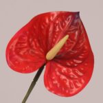 Red faux anthurium stem with glossy sculpted spathe and realistic spadix, ideal for wedding decor and bold event floral arrangements