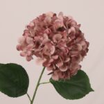 Mauve faux hydrangea stem with muted layered petals and realistic leaves, perfect for wedding decor and event floral arrangements