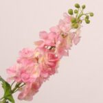 Pink faux delphinium spray with soft layered petals and greenery suitable for wedding decor and romantic event floral arrangements.