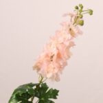 Peach faux delphinium spray with soft gradient petals and lush leaves designed for wedding decor and event floral arrangements.