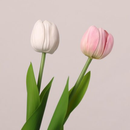 White and pink faux tulip stems arranged together with realistic leaves for elegant wedding or event décor accents