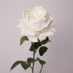 Cream white faux garden rose with soft layered petals and realistic green foliage for wedding and event floral arrangements