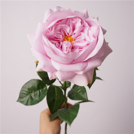 Light pink faux garden rose with full layered petals and vivid green leaves suitable for wedding decor and event arrangements