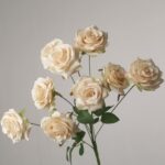 Champagne faux rose bouquet with layered petals and lush greenery ideal for wedding decor or elegant event arrangements