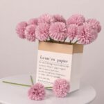 Pink artificial dahlia bouquet in paper bag for floral centerpiece