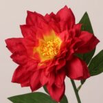 Red faux dahlia flower with layered silk petals and vibrant yellow center, ideal for wedding decor and event floral arrangements