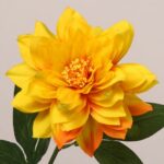 Yellow faux dahlia flower with full layered petals and realistic center for wedding decor and event floral use