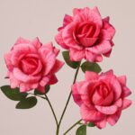 Pink faux rose spray with three realistic blooms and green leaves, ideal for wedding decor and event floral arrangements