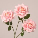 Blush pink faux rose spray with soft layered petals and natural green leaves for elegant wedding decor use