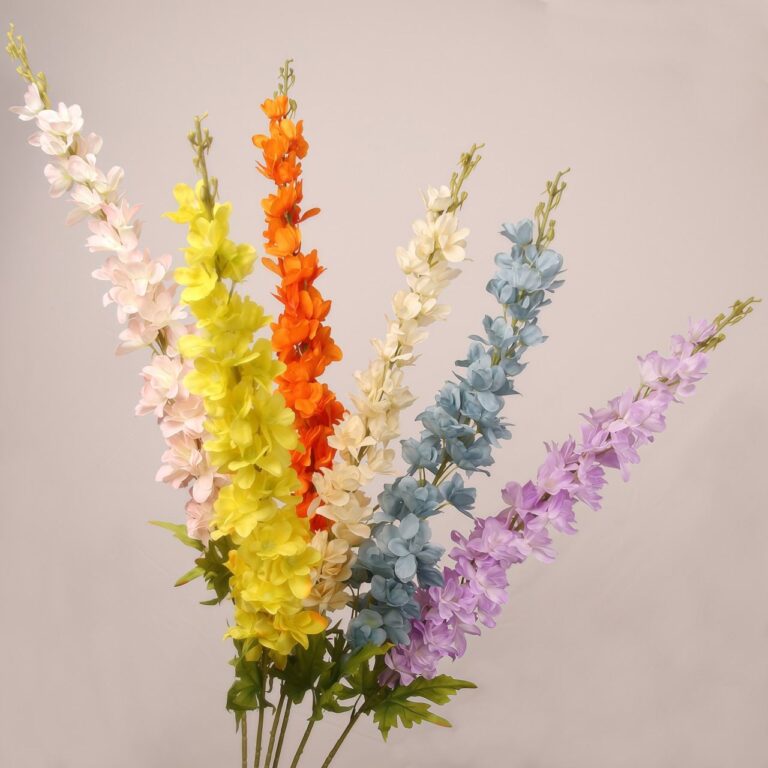 Mixed color faux delphinium stems arranged together with layered petals for wedding decor and event floral arrangements