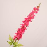 Hot pink faux delphinium stem with dense layered petals and natural greenery for wedding decor and event floral arrangements