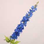 Royal blue faux delphinium stem with rich layered petals and realistic greenery for wedding decor and event floral arrangements