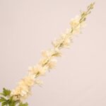 Ivory faux delphinium stem with elegant layered petals and natural greenery for wedding decor and event floral arrangement