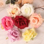 Assorted faux rose flower heads in multiple colors displayed together, ideal for wedding decor, event floral arrangement, and faux flowers selection