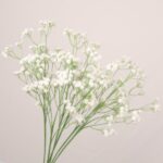 White faux baby's breath spray with airy branching stems for wedding decor and event floral arrangement