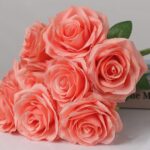 Coral pink faux rose bouquet with soft layered petals for wedding decor and vibrant event floral arrangement design