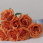 Burnt orange faux rose bouquet with realistic layered petals for wedding decor and autumn event floral arrangement