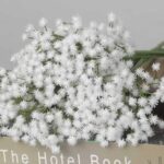 White faux baby's breath spray with clustered tiny blooms for wedding decor and soft event floral arrangement styling