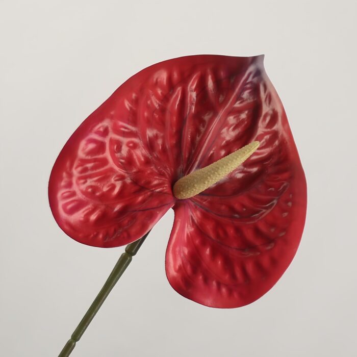 Red faux anthurium stem with glossy sculpted spathe and realistic spadix, ideal for wedding decor and bold event floral arrangements