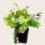 A lush bouquet of green flowers and foliage held by a person