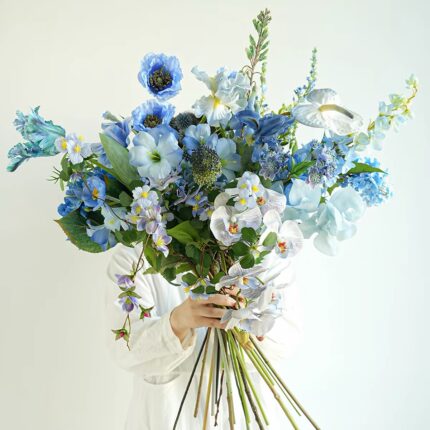 A lush bouquet of blue and white flowers with orchids and irises.