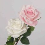 A pair of premium real-touch artificial rose stems, one pure white and one soft pink, with green leaves against a light grey background.