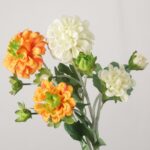 A side-by-side display of NB8Floral orange and white faux Dahlias showing realistic petal textures and stems.