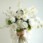 Elegant white flower bouquet with roses, calla lilies, and orchids