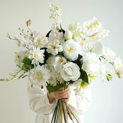Elegant white flower bouquet with roses, calla lilies, and orchids