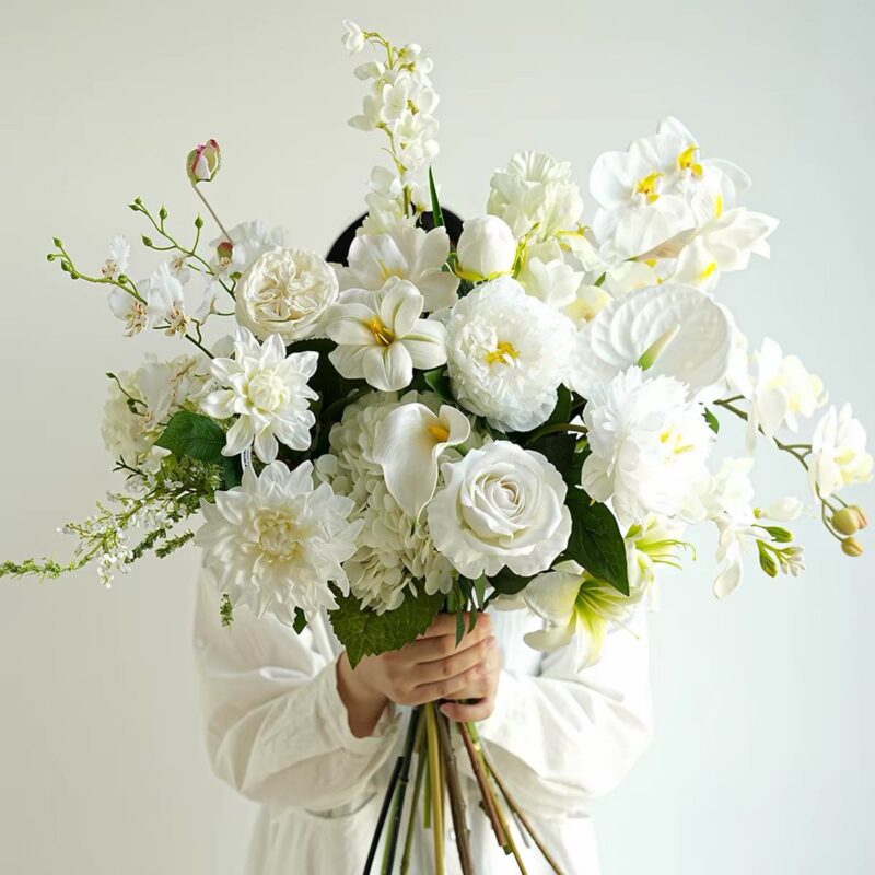 Elegant white flower bouquet with roses, calla lilies, and orchids