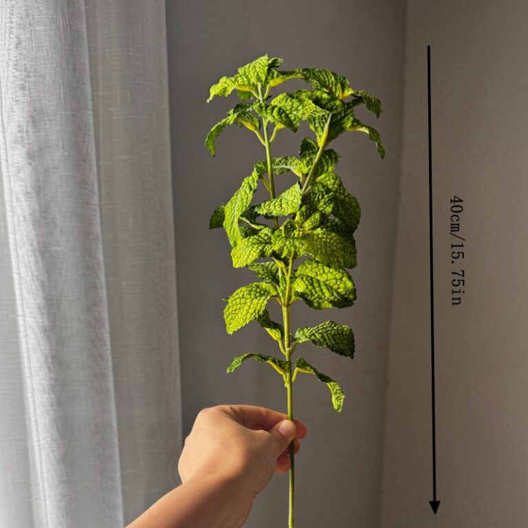 Green artificial leaf stem held in hand, 40cm (15.75 inch) long