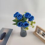 Artificial blue rose bouquet featuring seven silk roses arranged in a gray vase for home decor.