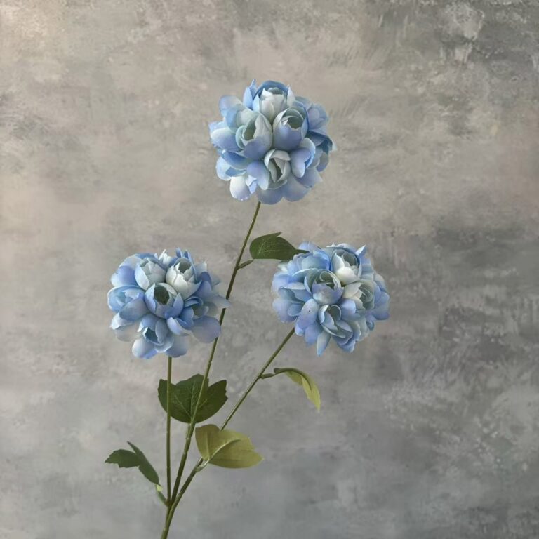 Three heads of realistic blue silk faux flowers ideal for wedding or home decor centerpieces.