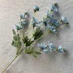 Realistic silk daisy stems suitable as artificial flowers for wedding centerpieces or home decor.