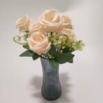 Bouquet of seven artificial peach roses in vase, perfect for home decor.