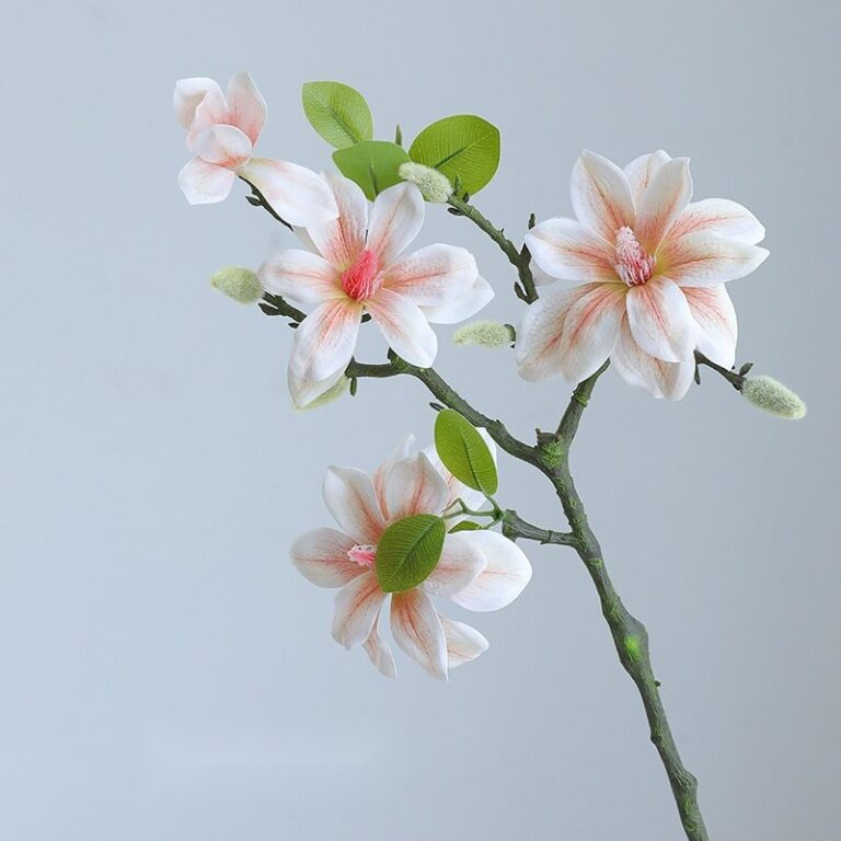 Artificial silk magnolia flowers on branches, featuring soft pink and white blooms for home decor.
