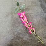 Artificial silk bluebells arrangement with pink flowers and green leaves.