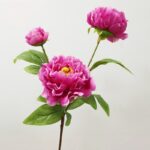 Silk artificial peony arrangement featuring three vibrant pink blooms and green foliage for realistic home decor.