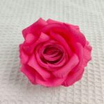Bright pink faux silk rose head measuring 10cm for home decor and floral arrangements.