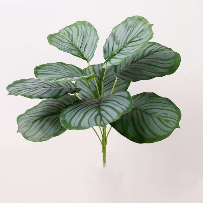 Faux tropical greenery cluster made of durable PVC artificial leaves for decorating homes or events.