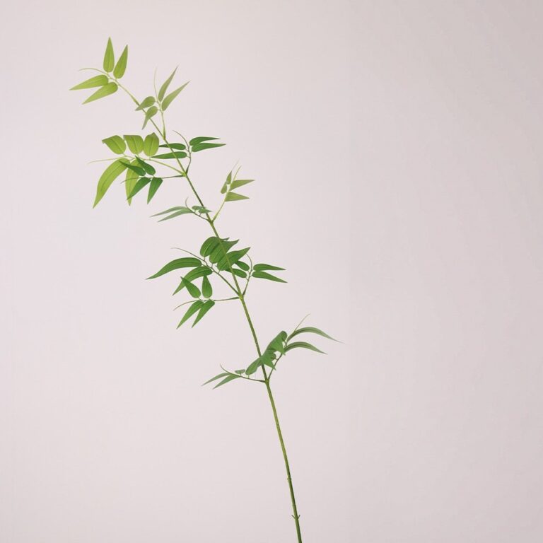 Artificial green plastic leaves cluster for craft decor and floral arrangements.
