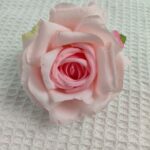 Realistic silk artificial rose head in light pink, perfect for permanent decor or floral arrangements.