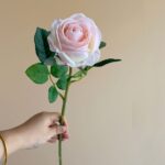 Realistic fake pink rose on a stem, perfect for artificial wedding flowers or home decor.