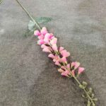 Realistic silk bluebell garland with pink blossoms on a gray textured background.