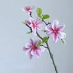Lifelike pink silk magnolia branches for artificial floral arrangement home decor.