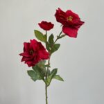 Artificial red clematis flowers arrangement with lush green leaves on a stem.