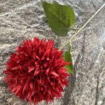 Realistic red silk pompon flower arrangement on gray stone, perfect for wedding or home decor.