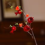 Artificial foam pomegranate branches featuring vibrant red berry clusters for holiday decor.
