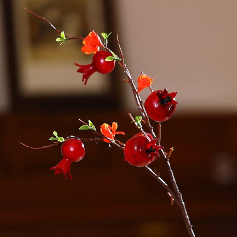 Artificial foam pomegranate branches featuring vibrant red berry clusters for holiday decor.