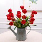 Red artificial silk tulips bouquet arrangement in a rustic metal vase for home decor.